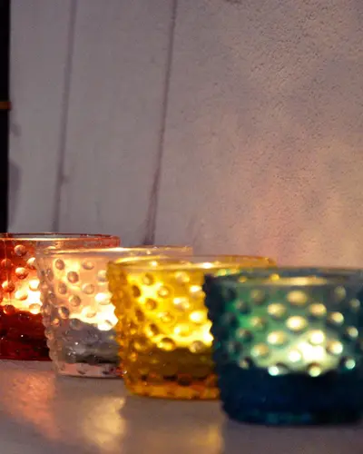 Glass candle holders in red, amber and blue